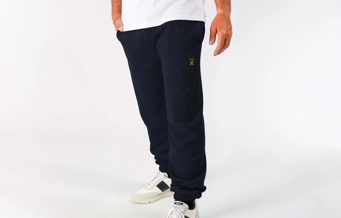Above Average Clothing joggers bearing the DRMMR Ascent logo with the drumsticks in place of the caret